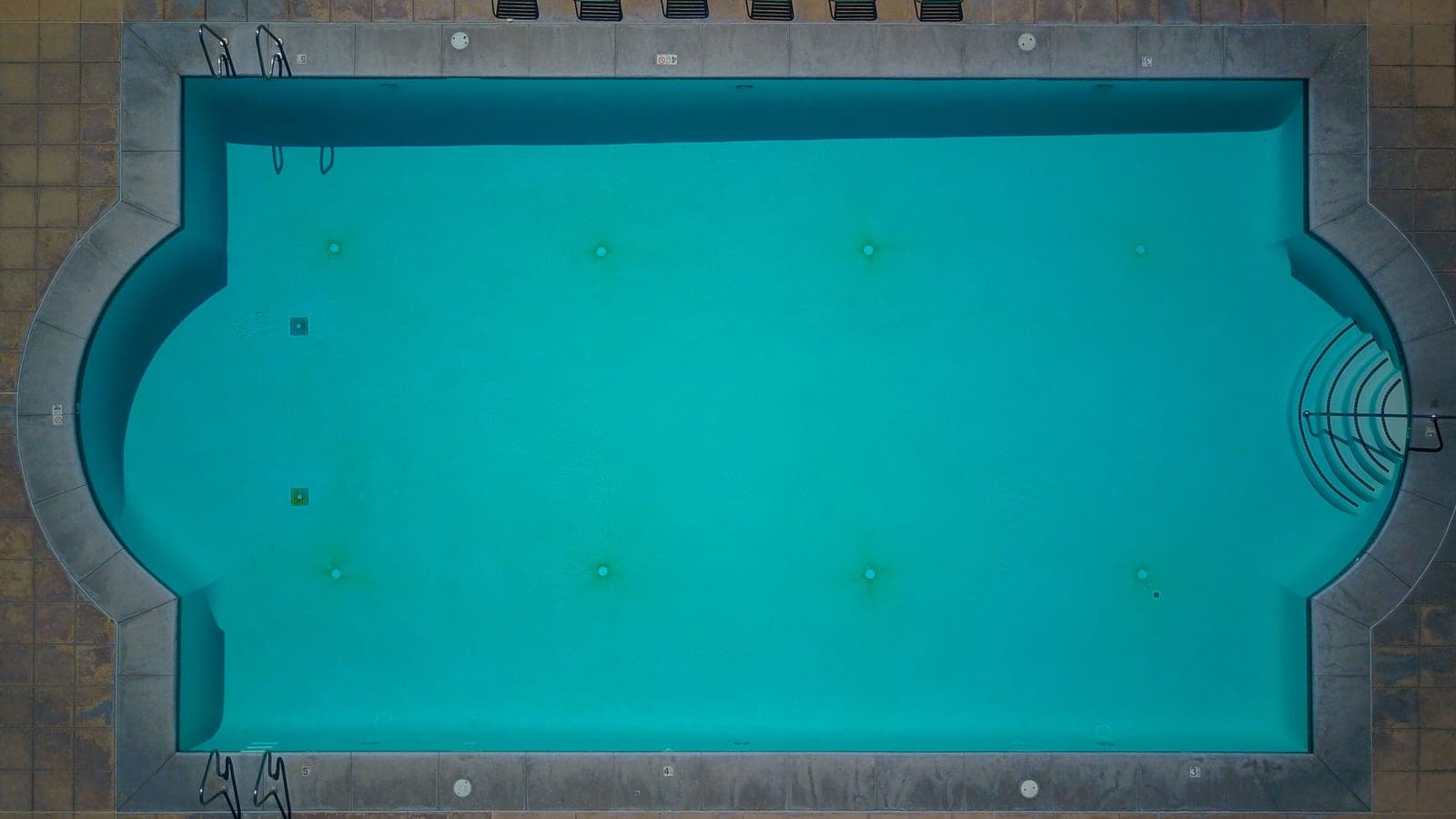 An above-ground swimming pool in a backyard setting