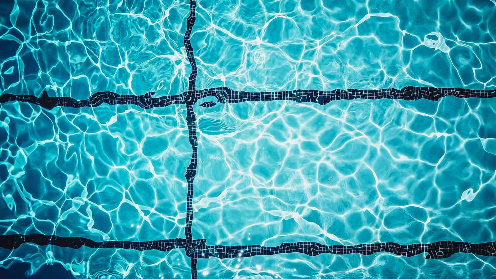 Pool water clearing from cloudy to blue after treatment