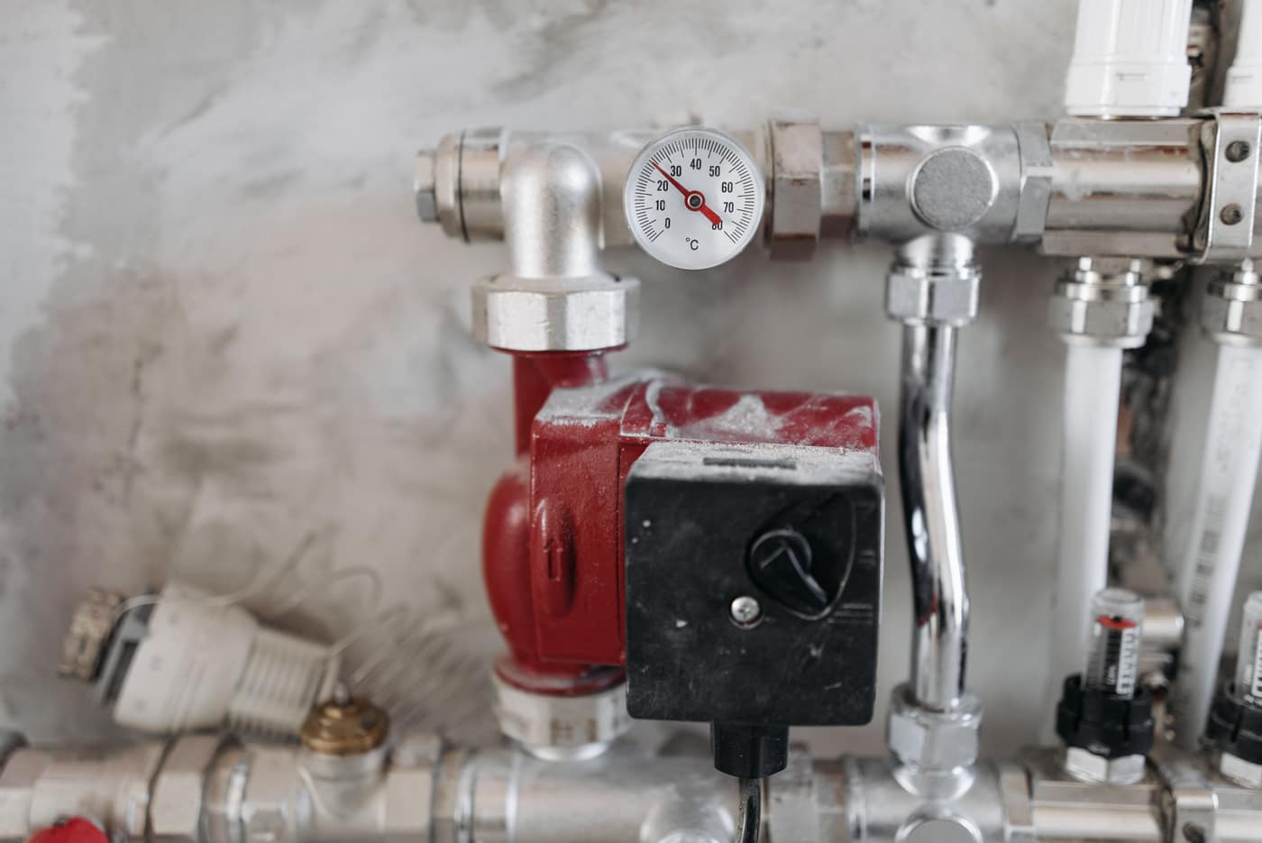 Pool filter housing and pump plumbing at a poolside equipment pad