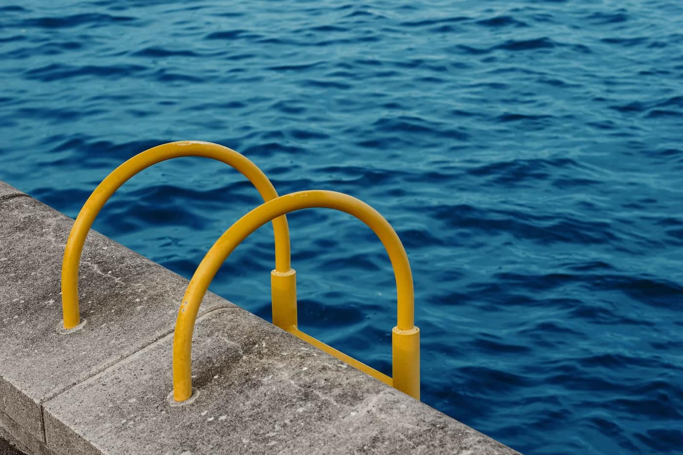 Organic debris collecting at the edge of a swimming pool