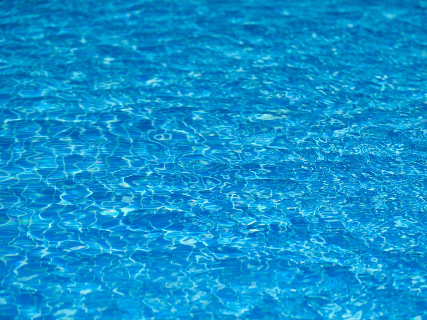Sunlit blue pool water