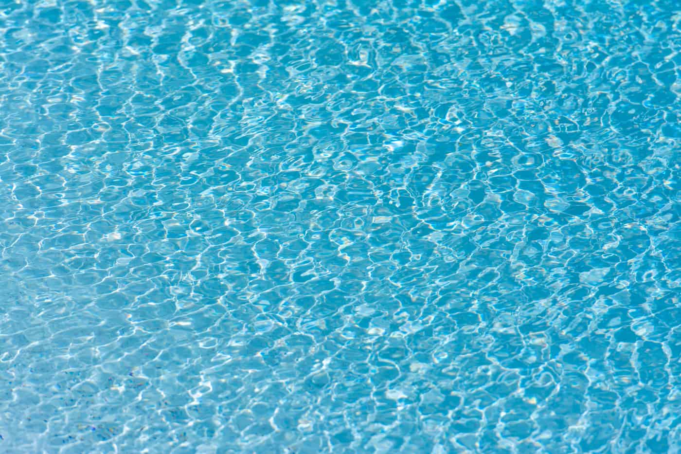 Clear turquoise saltwater pool surface in sunlight