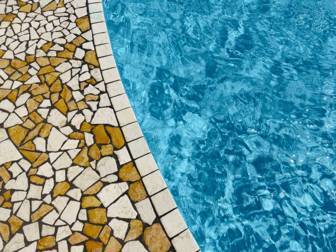 Mosaic tiles at the edge of a swimming pool