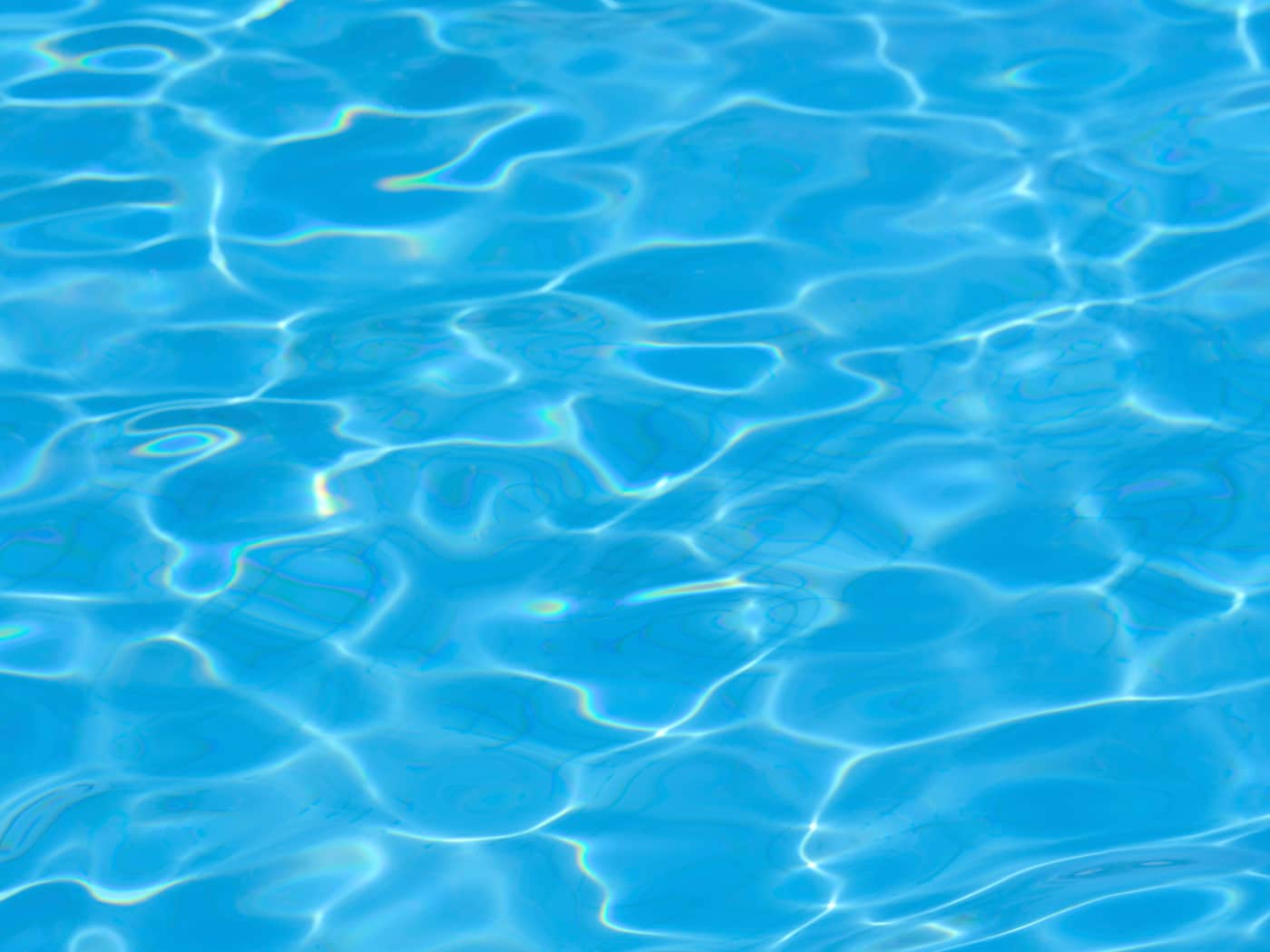 Sunlit ripples on a clear blue pool surface