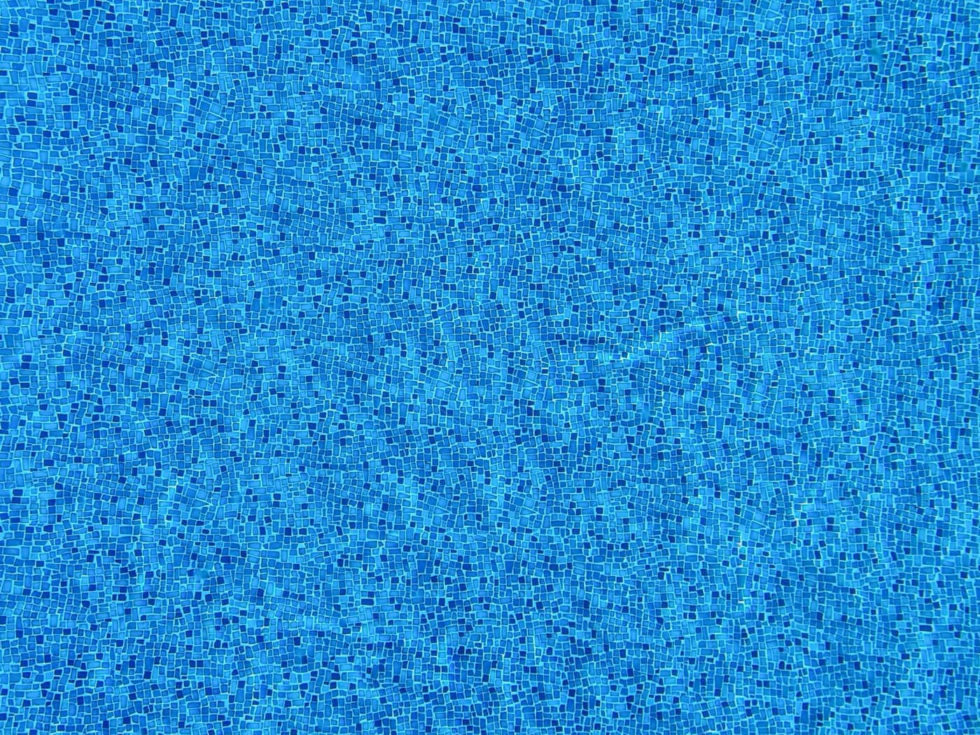 Blue mosaic tiles lining a swimming pool