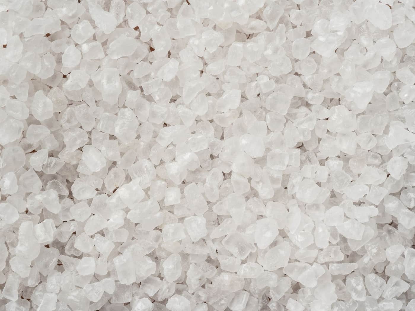 Coarse white salt crystals photographed close up