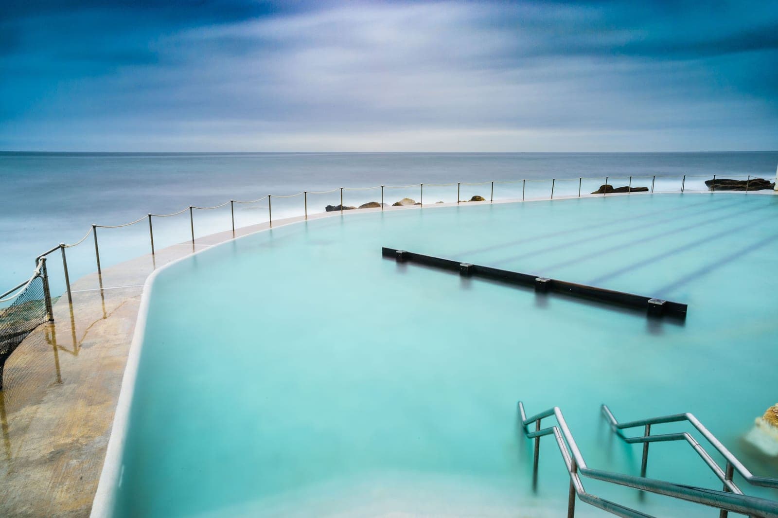 Clear blue saltwater swimming pool in sunlight