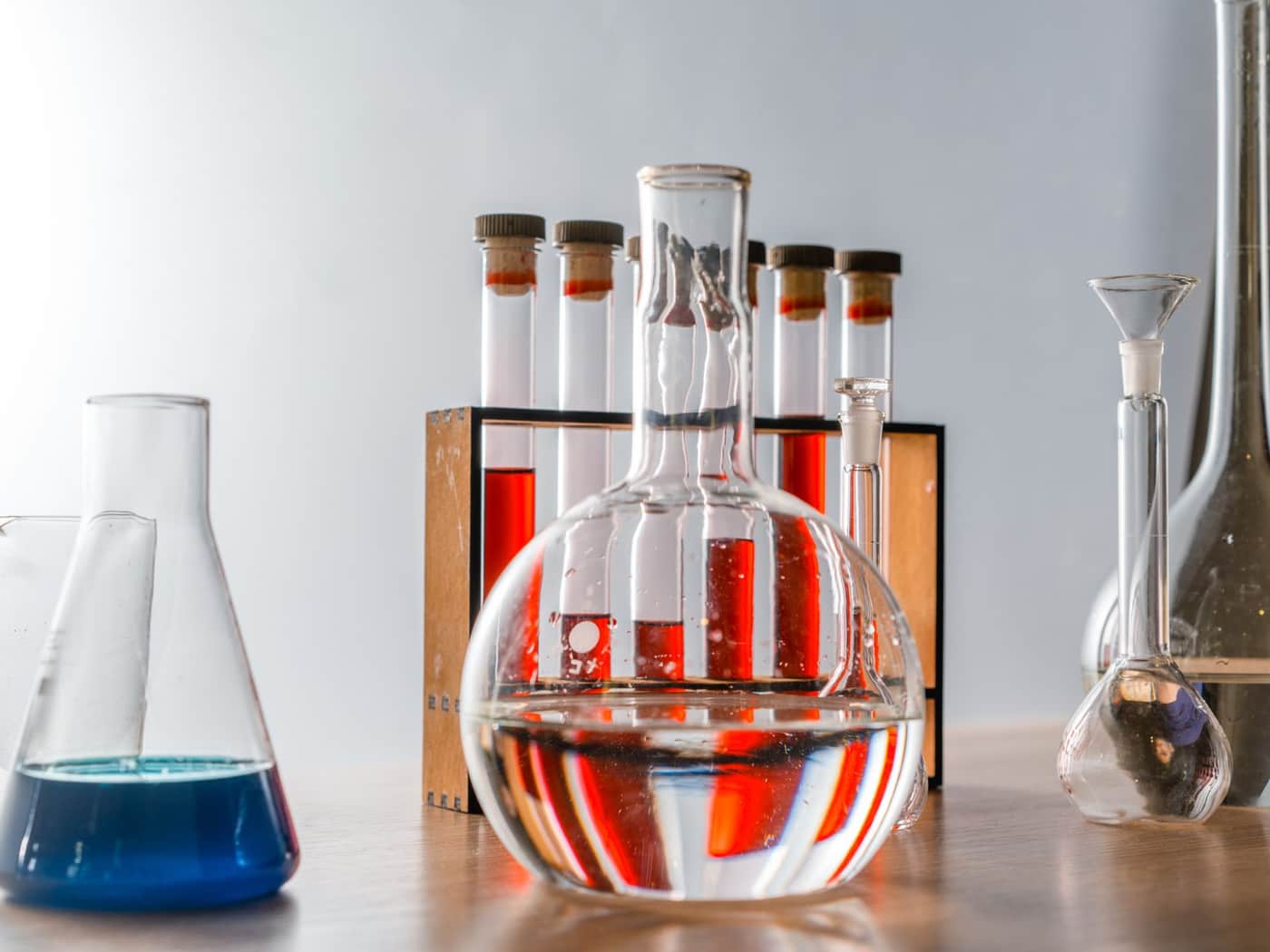 Laboratory glassware holding colored liquids in test tubes